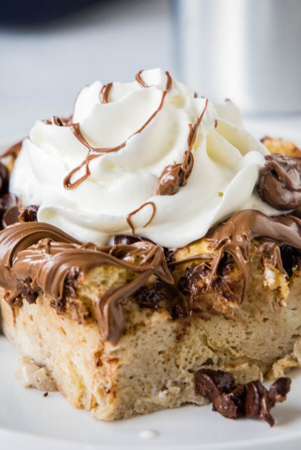close up chocolate french toast bake served on a white plate with whipped cream