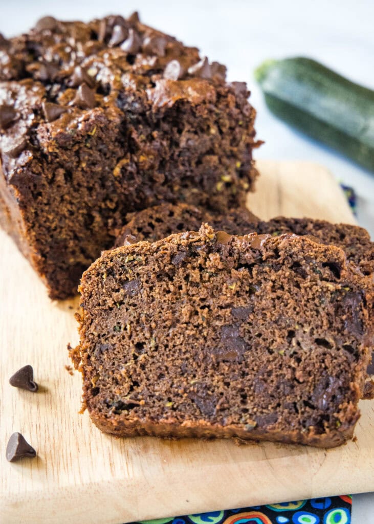 sliced chocolate zucchini bread on a wood cutting board