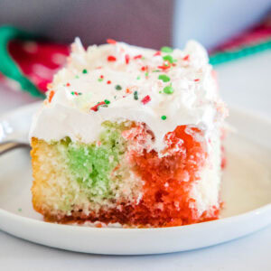 cropped close up christmas poke cake on white plate