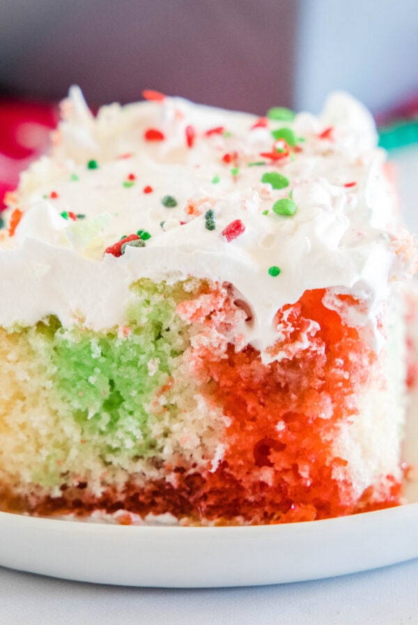 cropped close up christmas poke cake on white plate