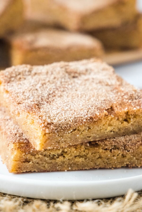 cropped close up stacked churro bars on a white plate