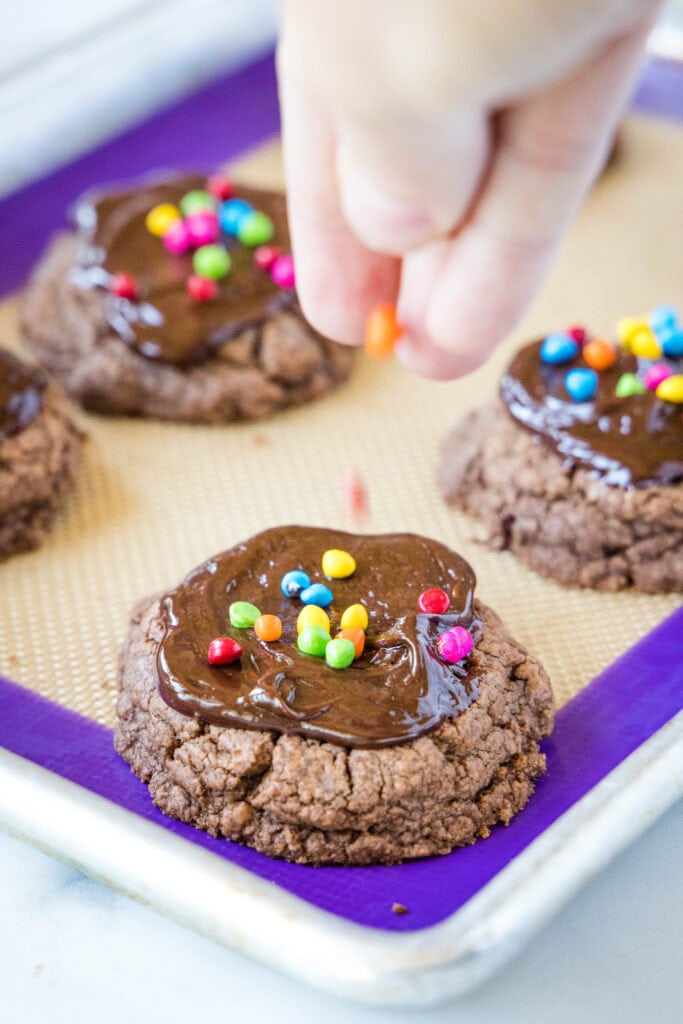 putting rainbow chips on cookies