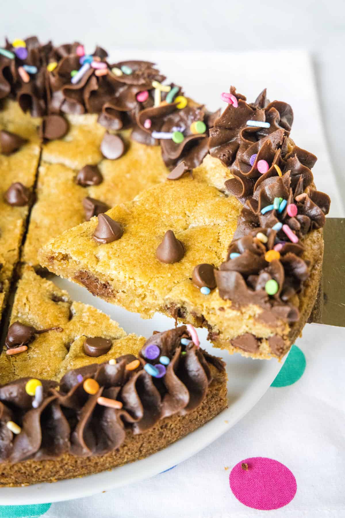 serving a slice of cookie cake from the platter