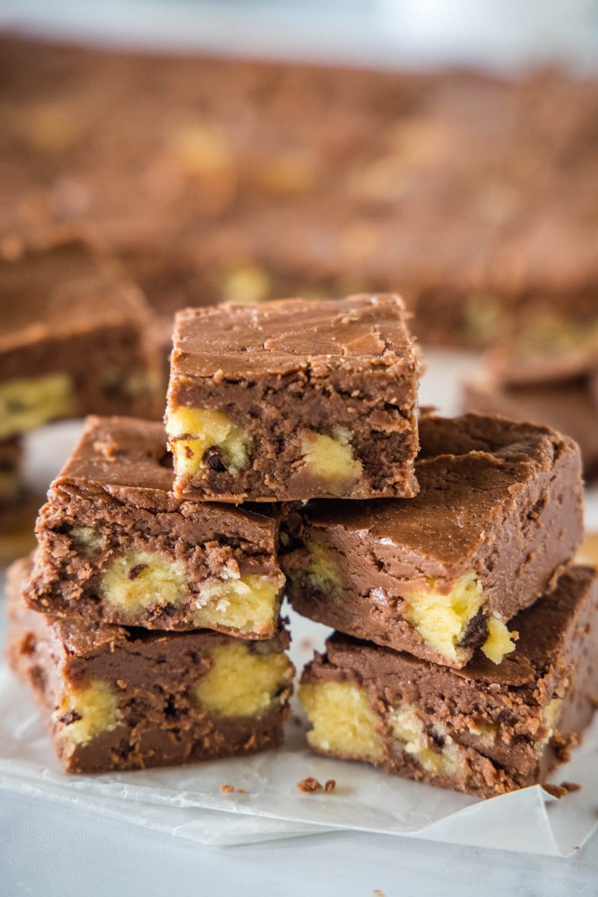 cookie dough fudge stacked up on cutting board