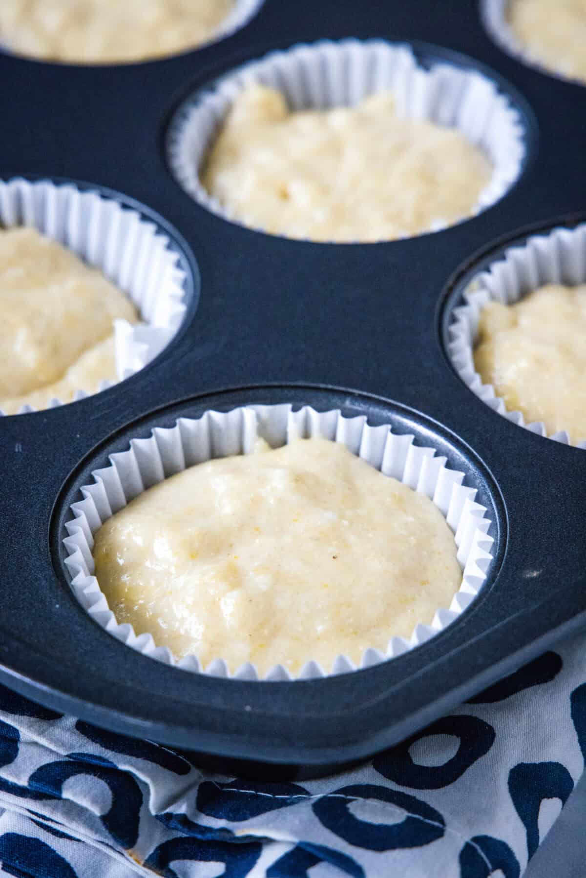corn muffin batter in muffin tin