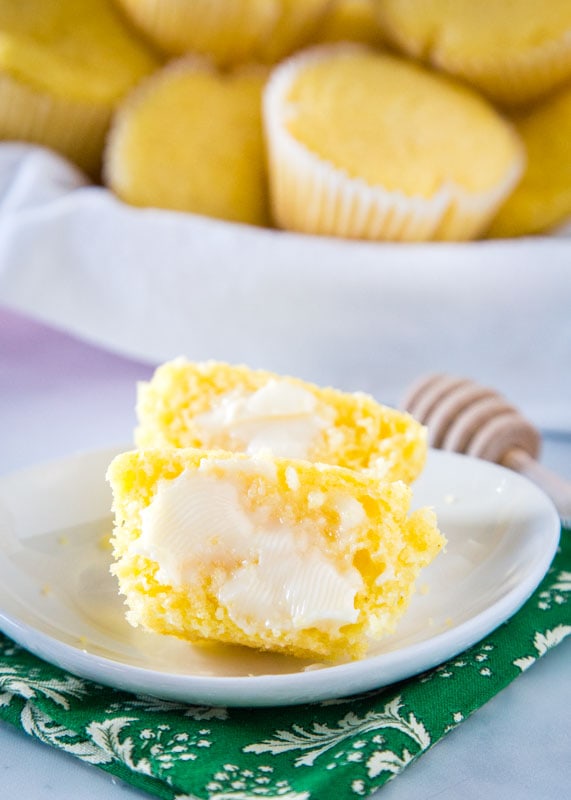 butter spread on corn muffin on a white plate