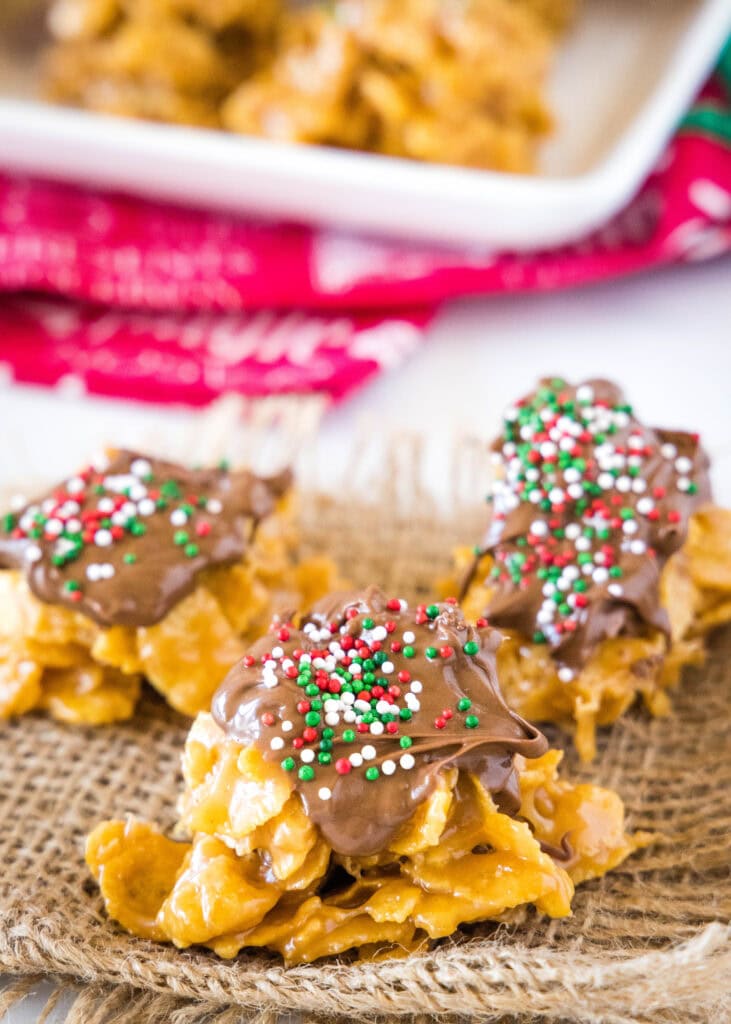 cornflake cookies topped with melted chocolate and sprinkles
