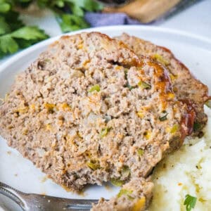 cropped close up slice of meatloaf on a plate