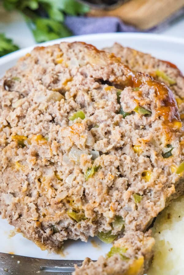 cropped close up slice of meatloaf on a plate