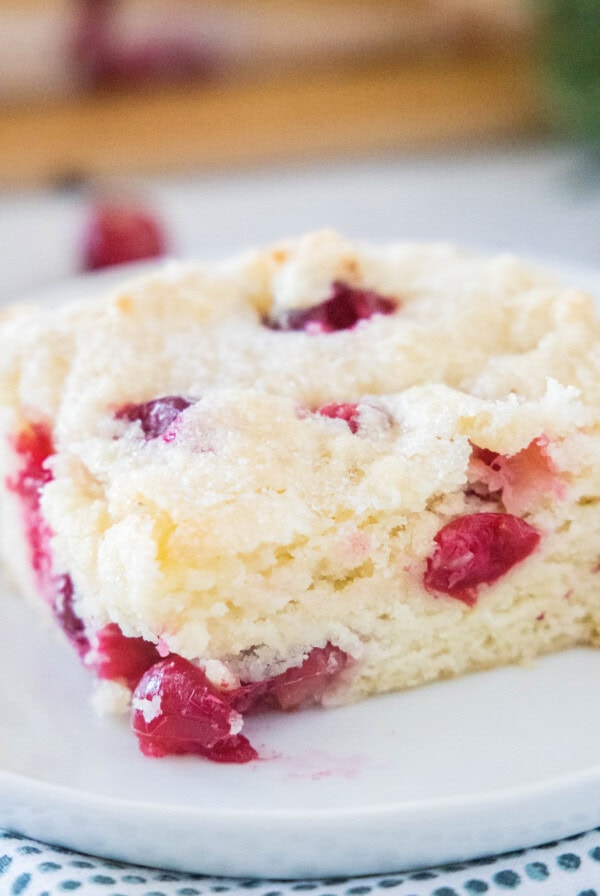 close up cranberry breakfast cake on a white plate