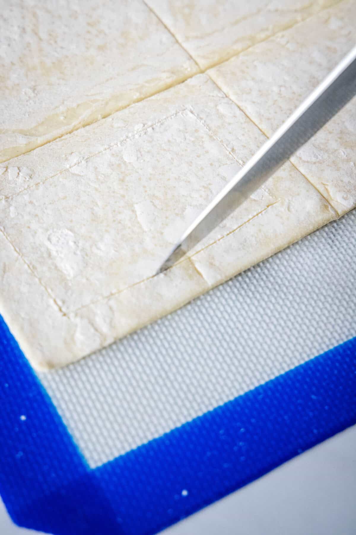 cutting an edge into the puff pastry