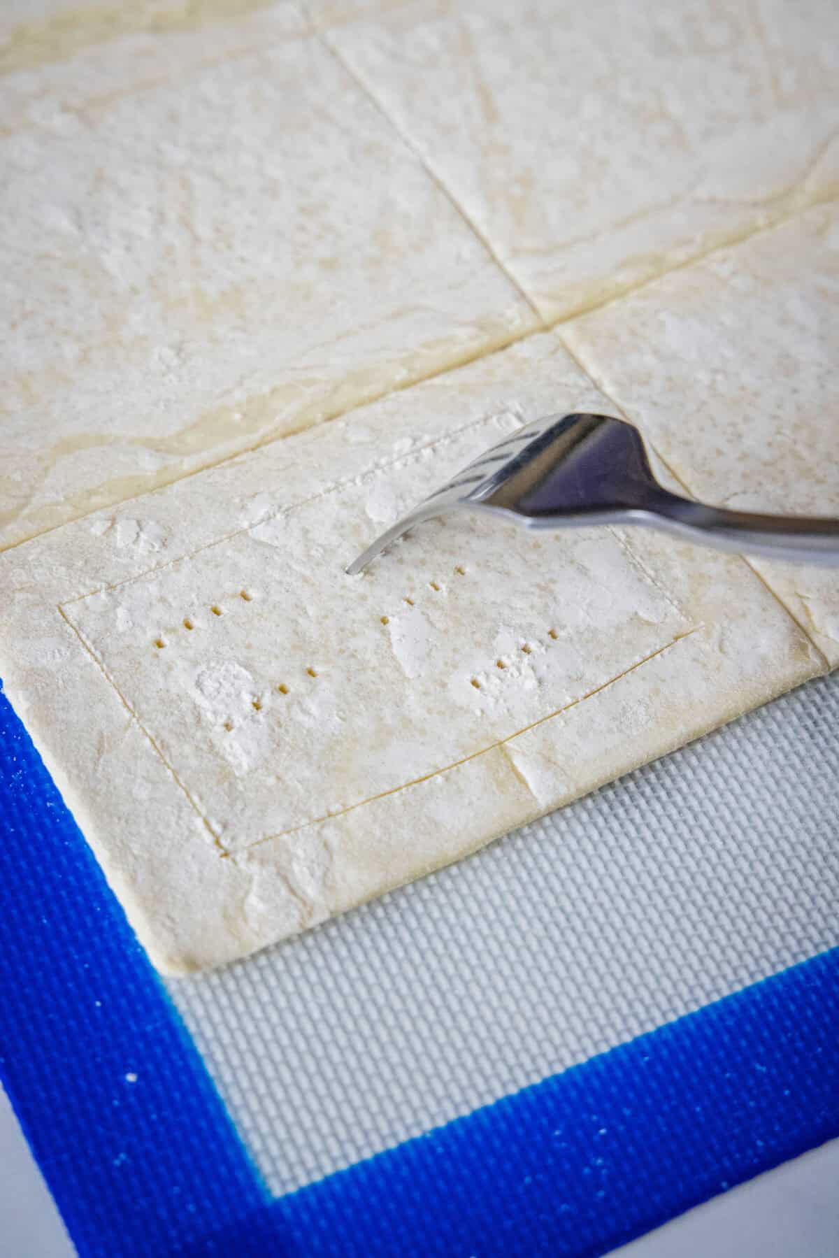 piercing puff pastry with a fork