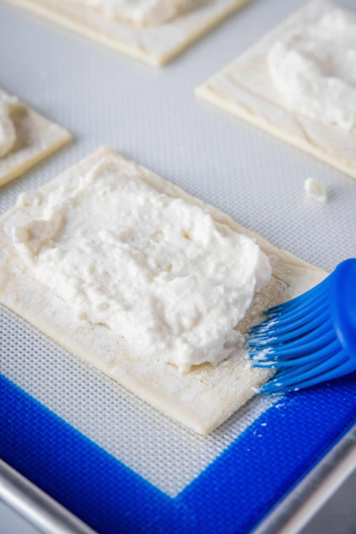 brushing edges of puff pastry
