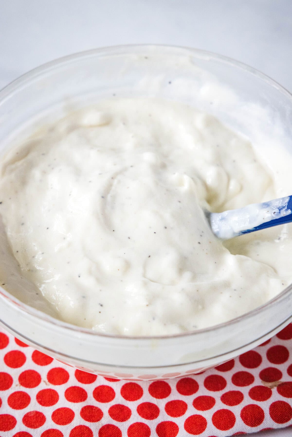 creamy garlic dressing mixed together in a bowl