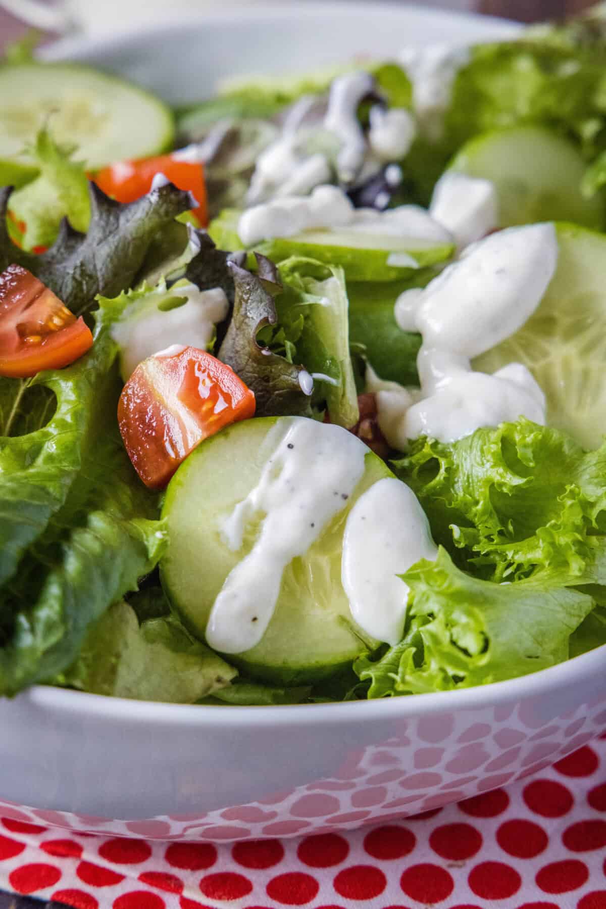 garlic dressing poured over a salad