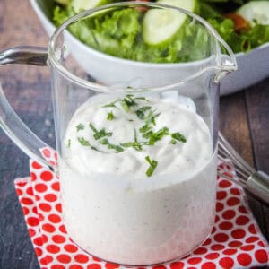 cropped close up creamy garlic dressing in a jar