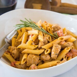 white bowl if creamy sausage pasta