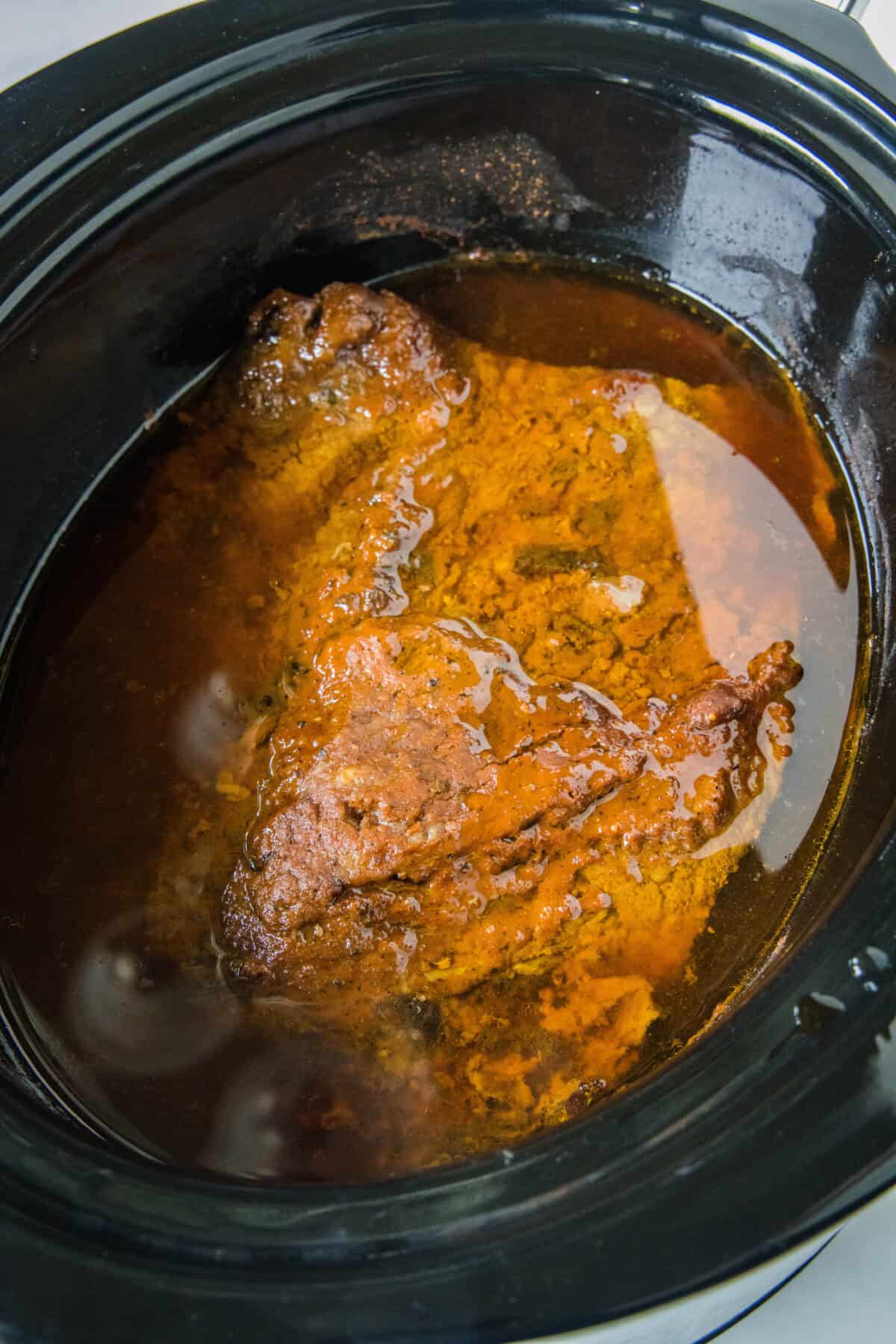 cooked brisket in a slow cooker