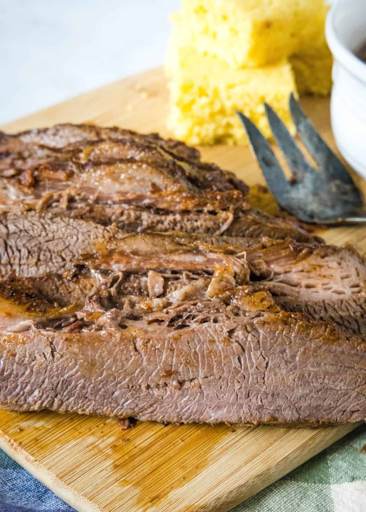 crockpot brisket sliced on cutting board