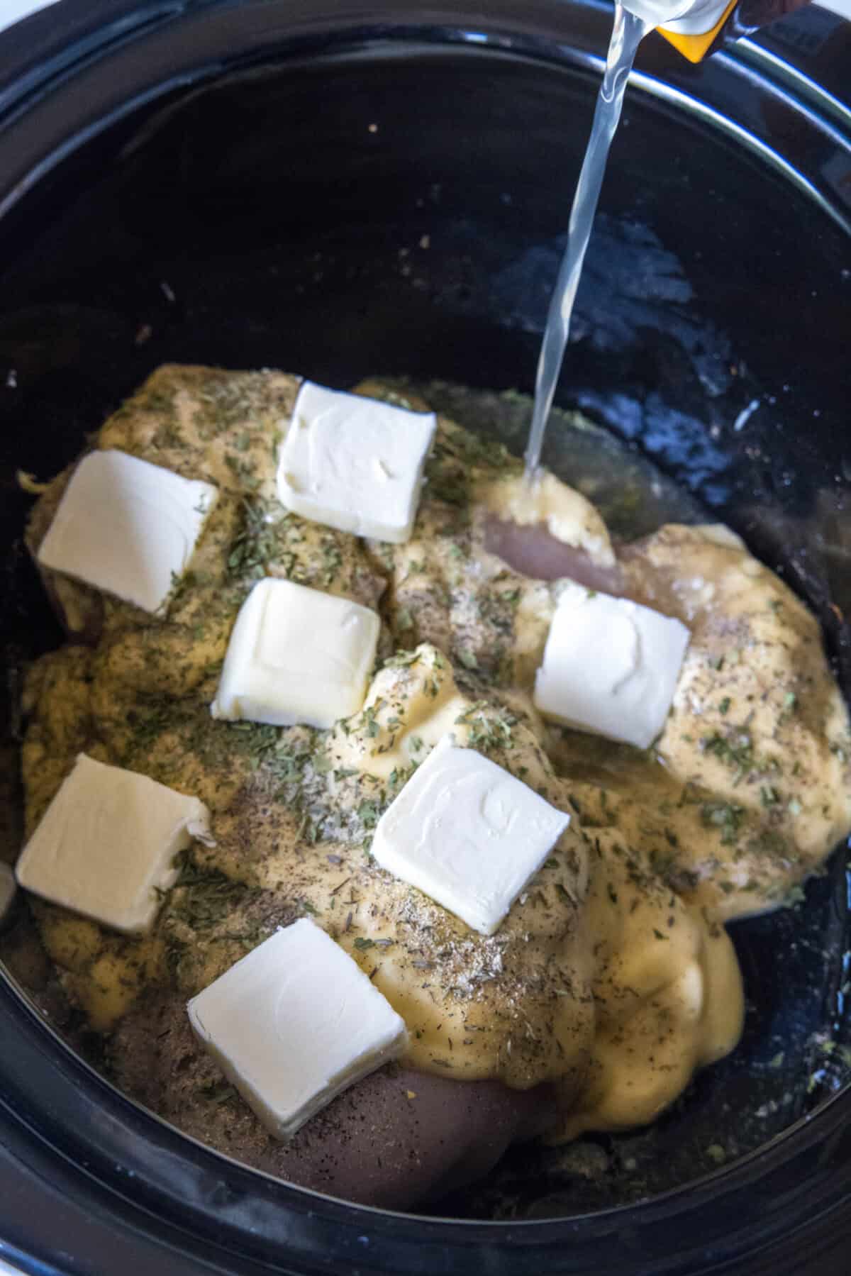 adding broth to crockpot