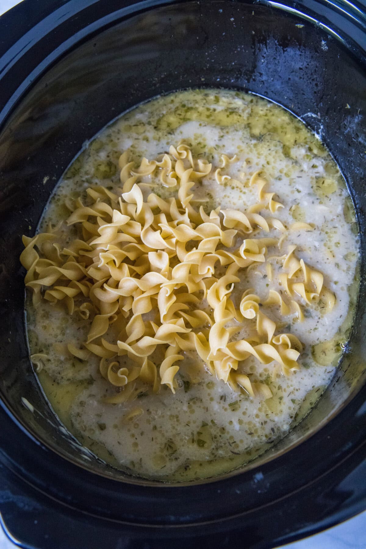 adding noodles to crockpot