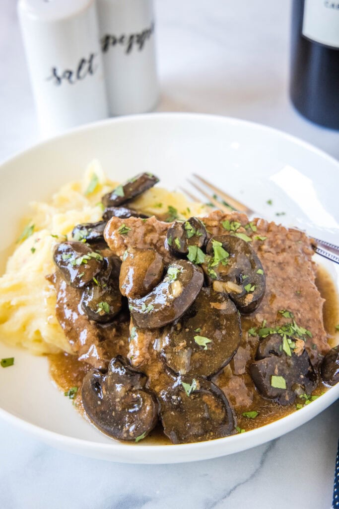 cube steak with mushroom gravy over mashed potatoes