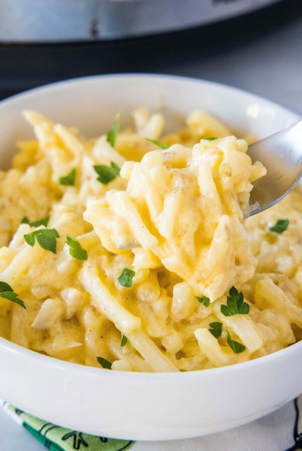 close up forkful of cheesy hashbrown casserole