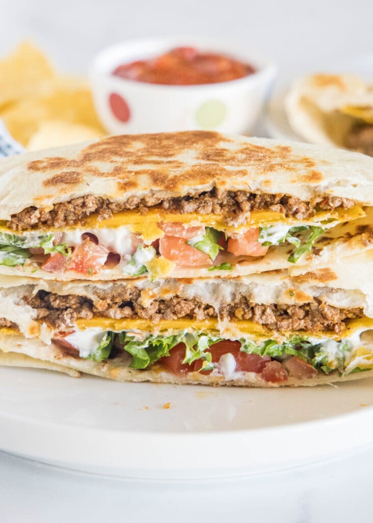 homemade crunchwrap supreme cut in half on a plate