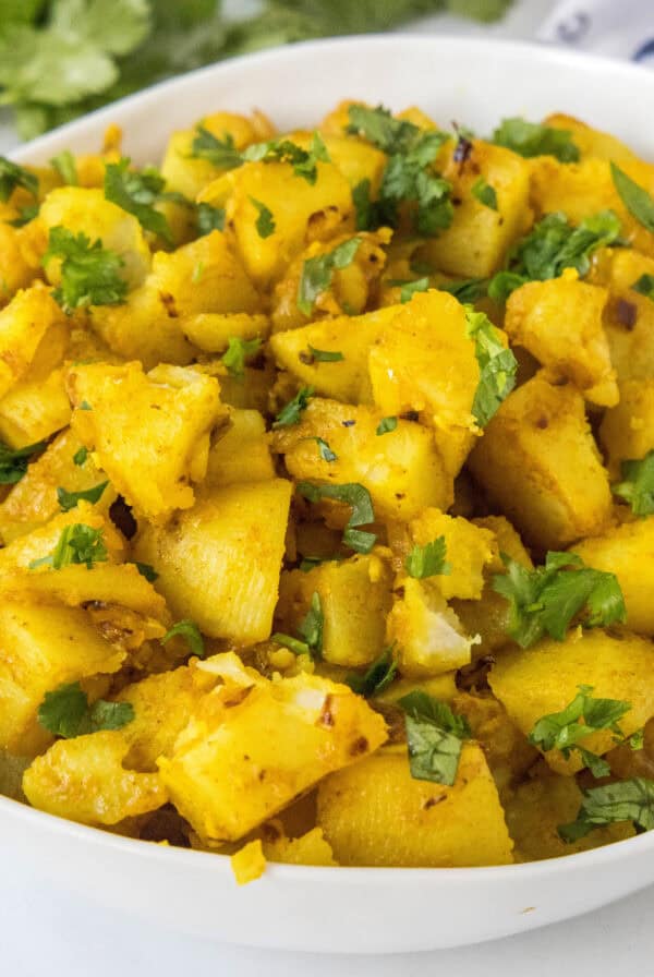 close up curried potatoes in a bowl