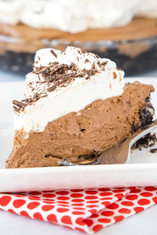 cropped square image of chocolate cream pie on white plate