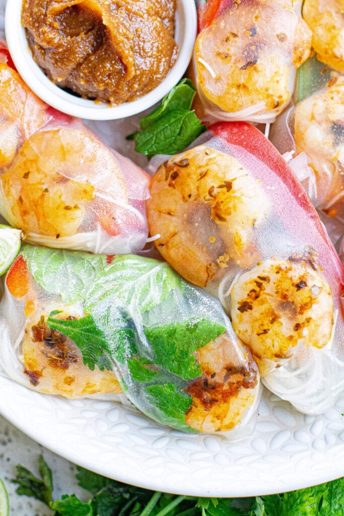 looking down at summer rolls on a white plate