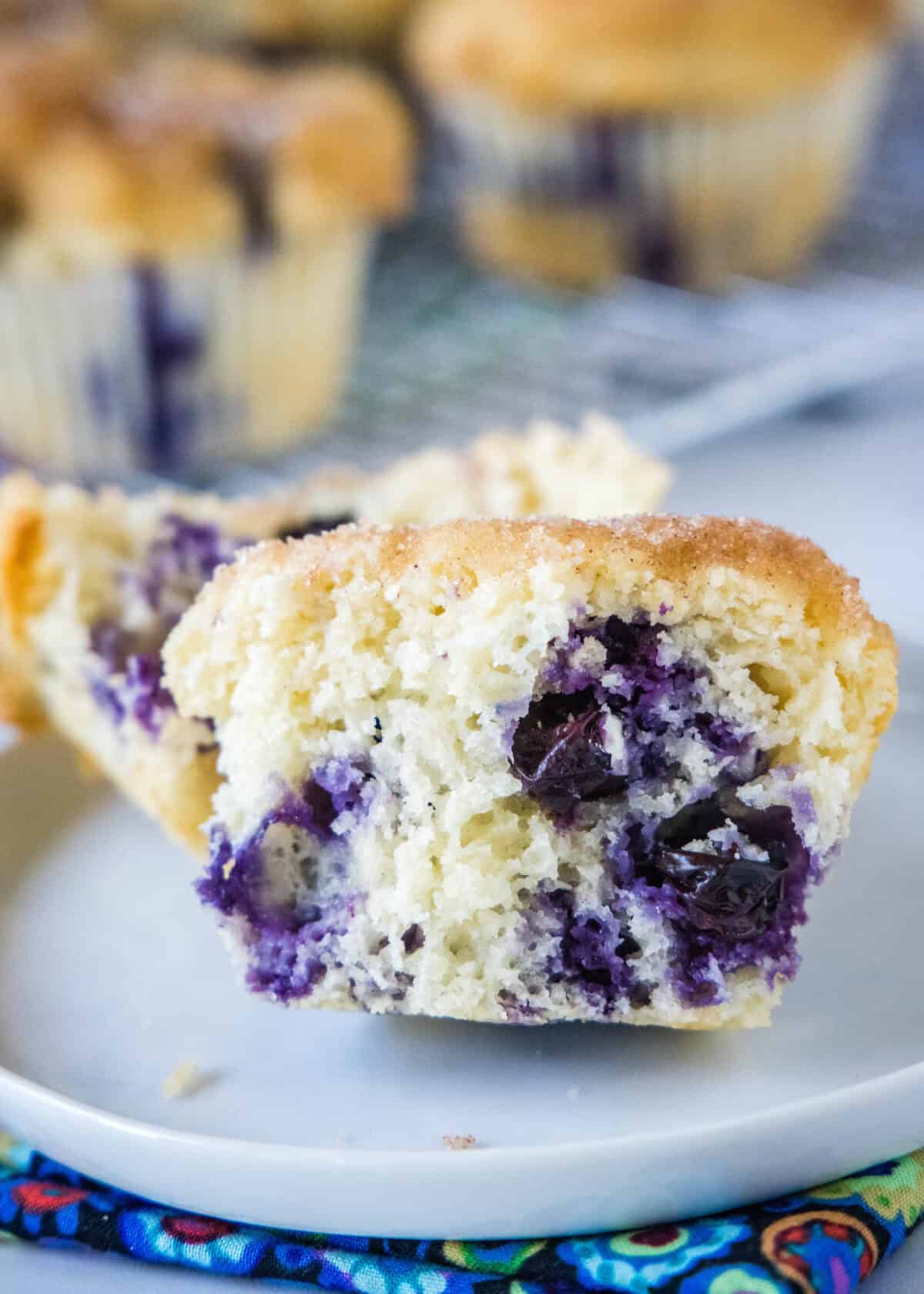 easy blueberry muffin broken in half on a white plate