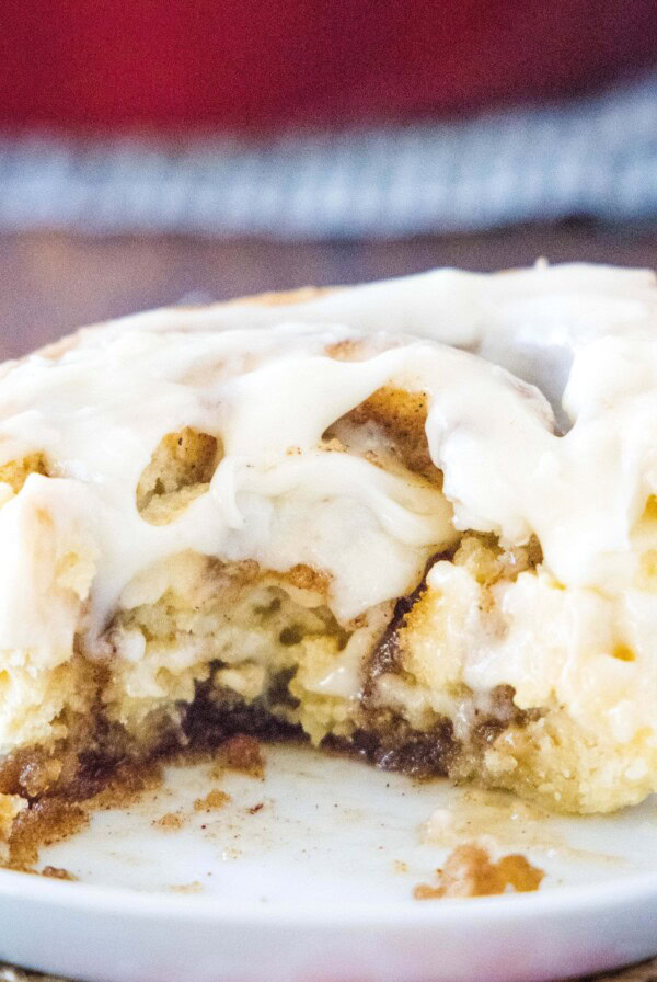cropped square image of eggnog cinnamon roll on white plate