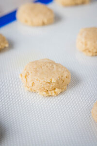 flattened ball of dough on a baking sheet