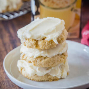 close up stacked eggnog sugar cookies on a white plate
