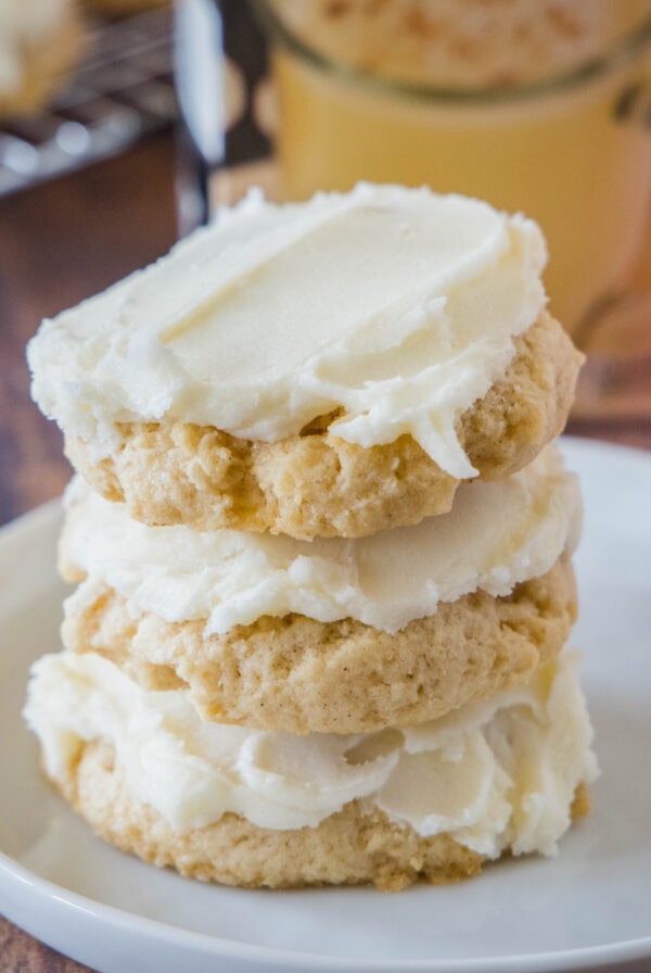 close up stacked eggnog sugar cookies on a white plate