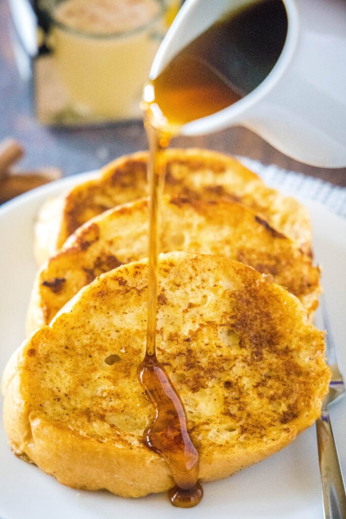 pouring syrup over french toast
