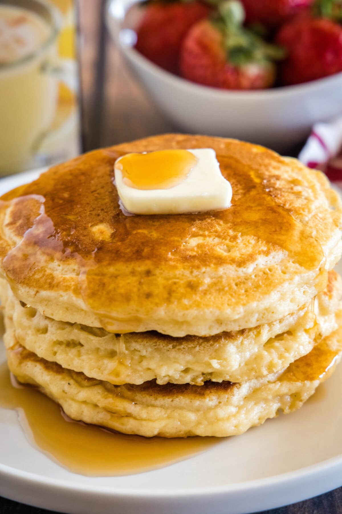 eggnog pancakes with syrup on a plate