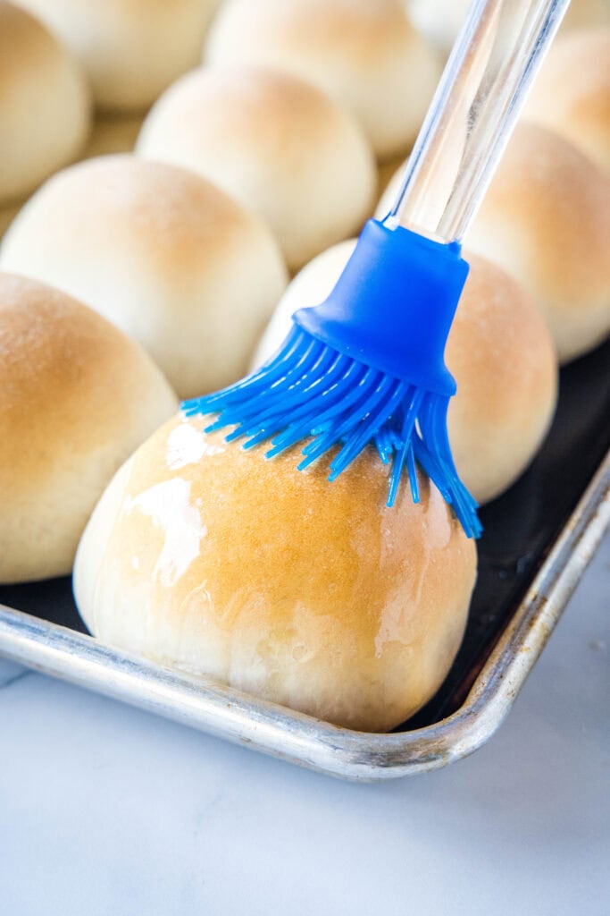brushing rolls with melted butter