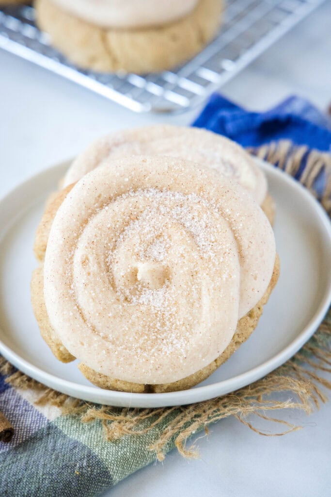 frosted churro cookies on a white plate