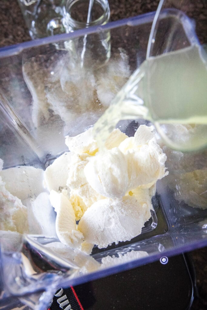 pouring lemonade into blender with ice cream