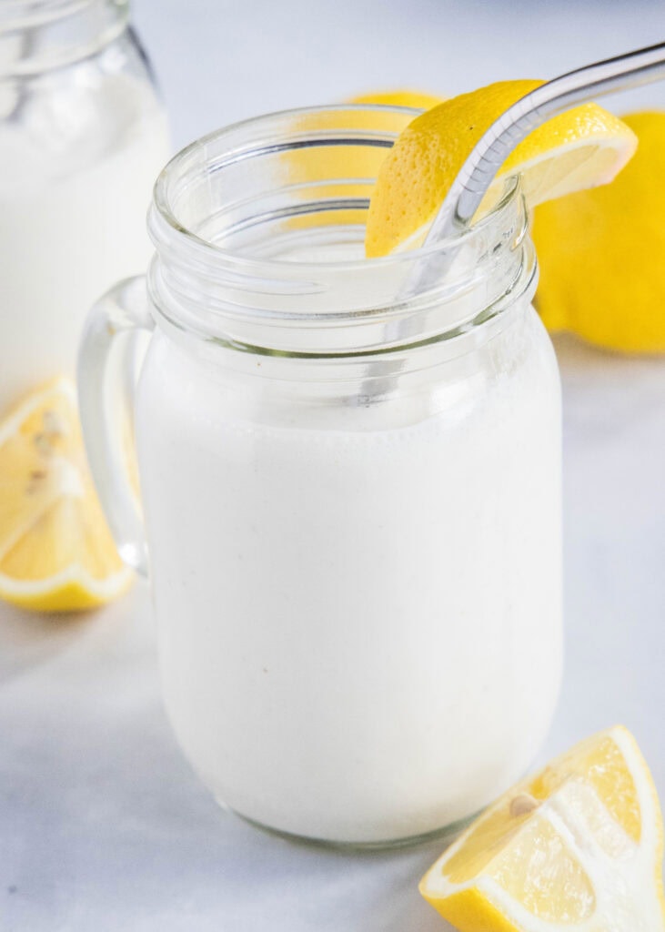 frosted lemonade in a glass with a straw