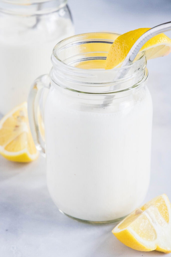 frosted lemonade in a glass with lemon slices