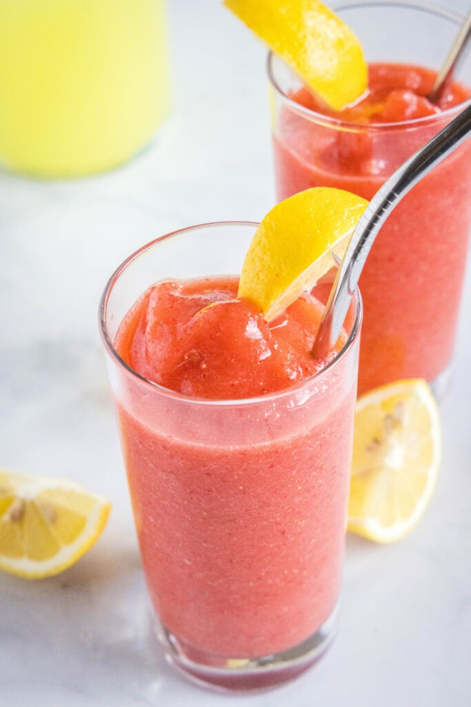 frozen lemonade in a glass with a metal straw