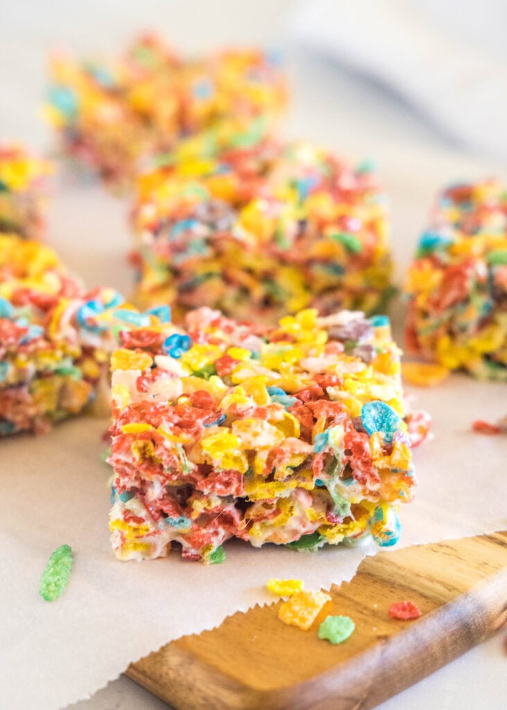 fruity pebbles krispie treats sliced on a cutting board