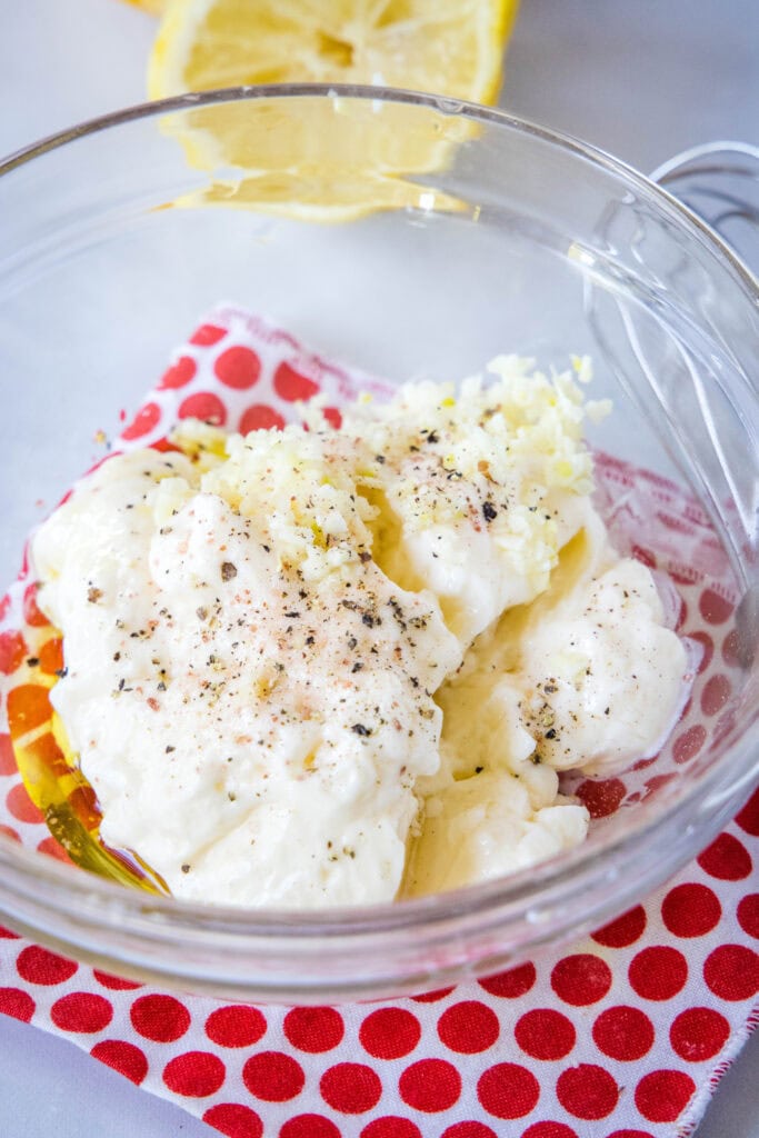 mixing together garlic aioli in a small bowl