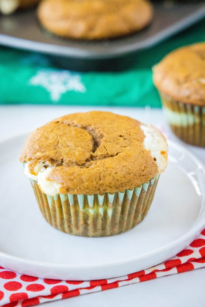 gingrebread cream cheese muffin on a white plate