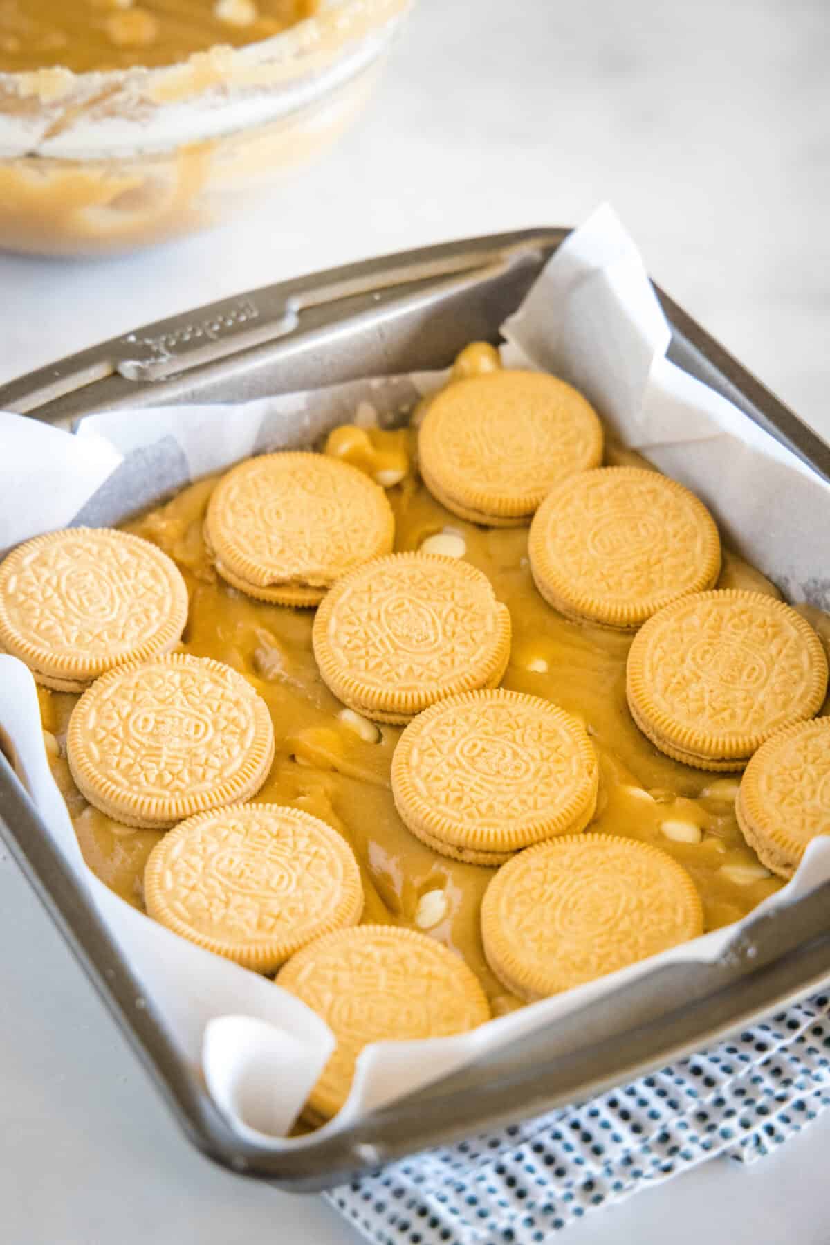 arranging golden oreos over blondie batter