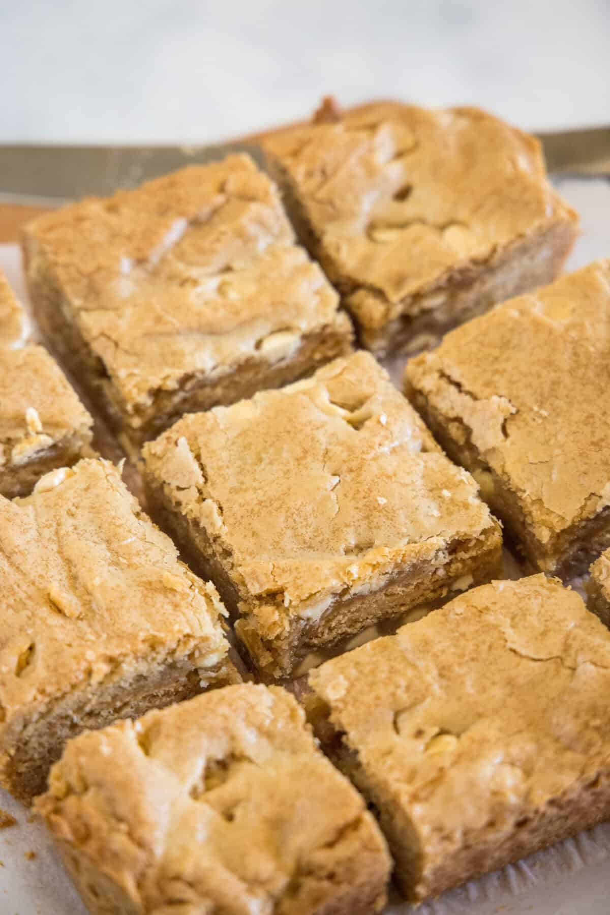 sliced golden oreo bars on a cutting board