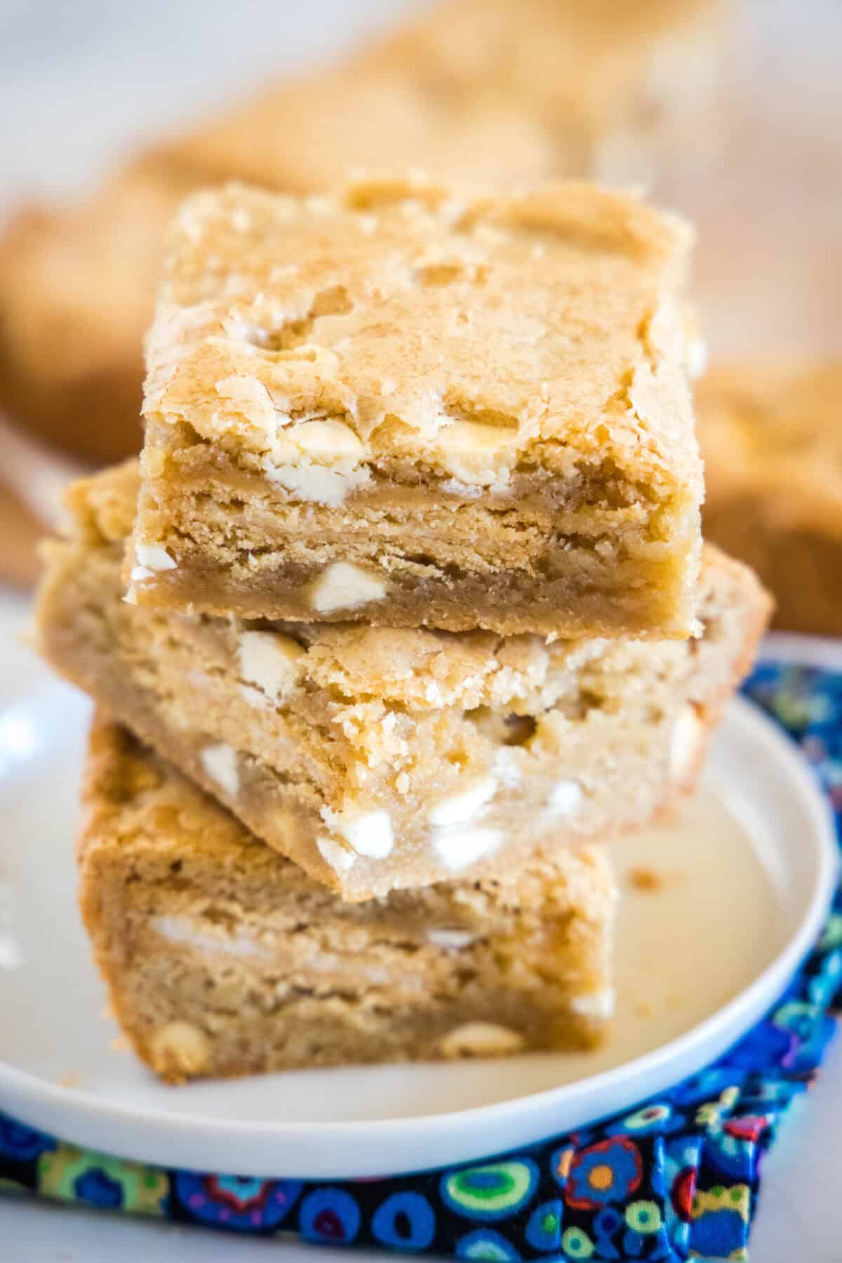 Golden Oreo Blondie Bars stacked golden oreo blondies on a white plate